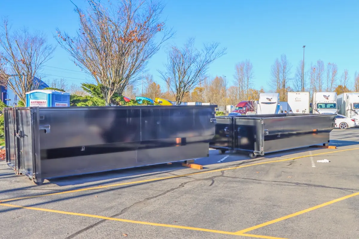 Professional dumpster rental service with roll-off container on residential driveway in Fair Lawn